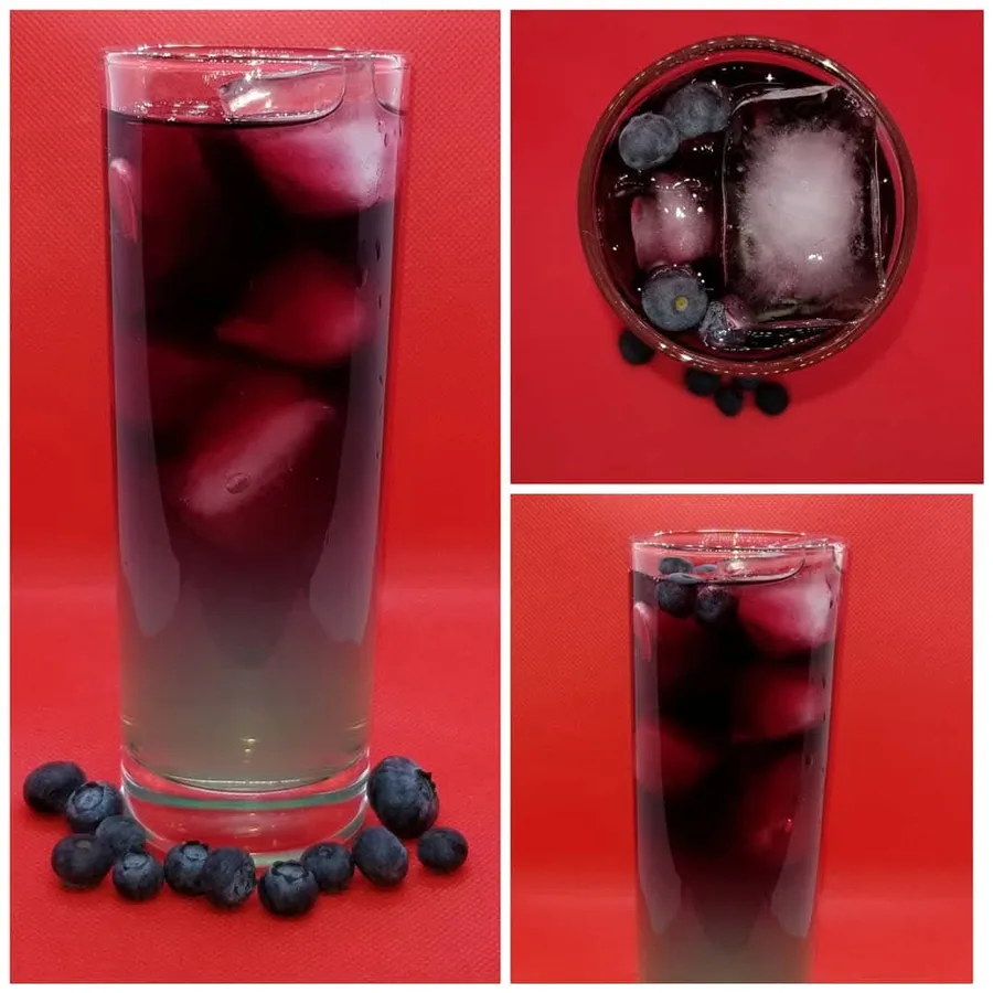 Red Moon over Blue Horizon cocktail shown from the side and above with blueberries