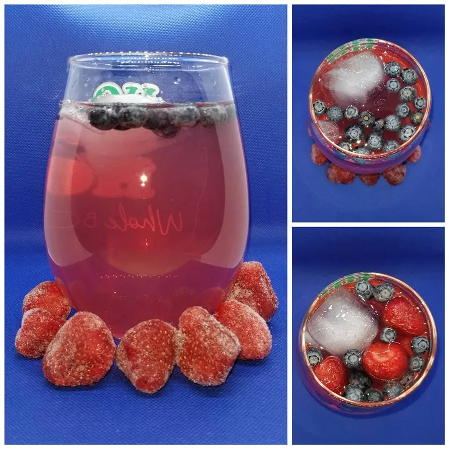 White Sangria shown from the side and above with frozen strawberries and blueberries